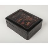 A Japanese Meiji period lacquered box and cover of rectangular form. Fitted with a tray and a