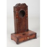 A George III inlaid mahogany architectural pocket watch stand. With swan neck pediment, pilasters,