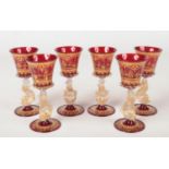 A set of six early-mid 20th century Venetian ruby glass and gilt goblets. Each decorated with scenes