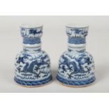 A pair of Chinese blue and white candle stands. Painted in underglaze blue with dragons chasing