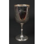 A large Victorian silver goblet by Josiah Williams & Co. With foliate engraving and raised on a