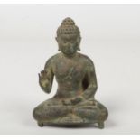 An antique Oriental verdigris small bronze devotional statue of a seated Buddha, 11cm. Missing