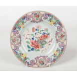 An 18th century Chinese famille rose plate decorated with peonies and prunus blossom, 22.75cm
