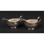 A pair of fine quality George III silver sauceboats by Charles Wright. With double scrolling