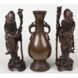A pair of early 20th century Chinese carved hardwood figures each formed as a sage and with silver