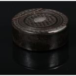 A Georgian carved ebony and silver mounted snuff box of circular form and with hinged cover, 4.