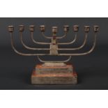 A silver presentation menorah by Emile Viner. With detachable centre nozzle and raised on a