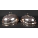 Two silver plated meat covers of ovoid form. Each with gadrooned mouldings and having cast scroll