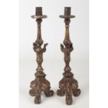 A pair of 19th century Continental carved and gesso candlesticks of Neo-Classical form. Adorned with