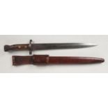 A Victorian bayonet in leather scabbard. Stamped with a crowned VR and with War Department