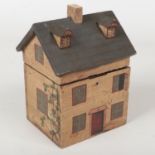 A 20th century painted tea caddy in the form of a cottage, 21cm high.