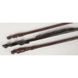 Three African carved hardwood staffs. Each with a figural top and one formed as a soldier. Largest