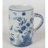 A 19th century blue and white delft cylindrical tankard with plain loop handle. Painted with a