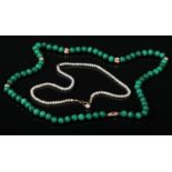 A malachite bead necklace interspersed with 14 carat gold beads and clasp along with a pearl