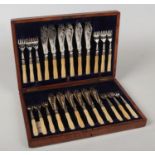 An oak cased canteen of silver plated fish knifes and forks by Briddon Brother, Sheffield. For 12