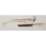 An inuit antler dagger and scabbard. With penwork decoration depicting reindeer, 36cm.