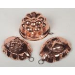 A 19th century copper jelly mould and a pair of oval fruit moulds. Jelly 19cm diameter. All with