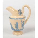 A Brameld caneware jug with horse tail and hoof handle. Sprigged in blue with Neo-Classical putti.