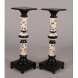 A pair of Hungarian Zsolnay pottery and ebonised wood torcheres. With knopped pedestals and raised