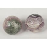 Two carved and polished amethyst spheres, 6.5cm diameter.
