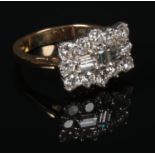 An 18 carat gold diamond cluster ring. Set with three baguette cut diamonds under a frame of
