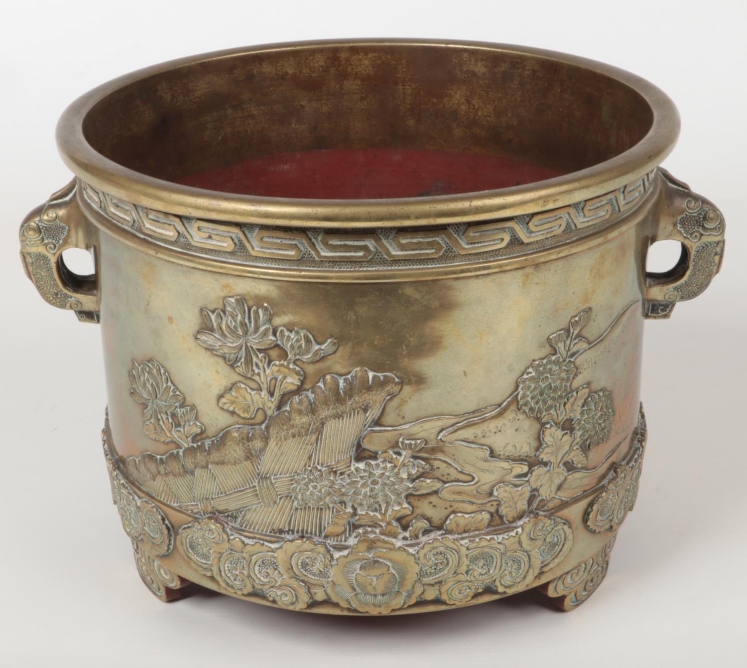 A Japanese Meiji period bronze planter. With twin elephant mask handles and decorated in relief with