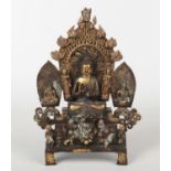 A Chinese bronze Buddhistic devotional group. Raised on a stepped base and with inscriptions to