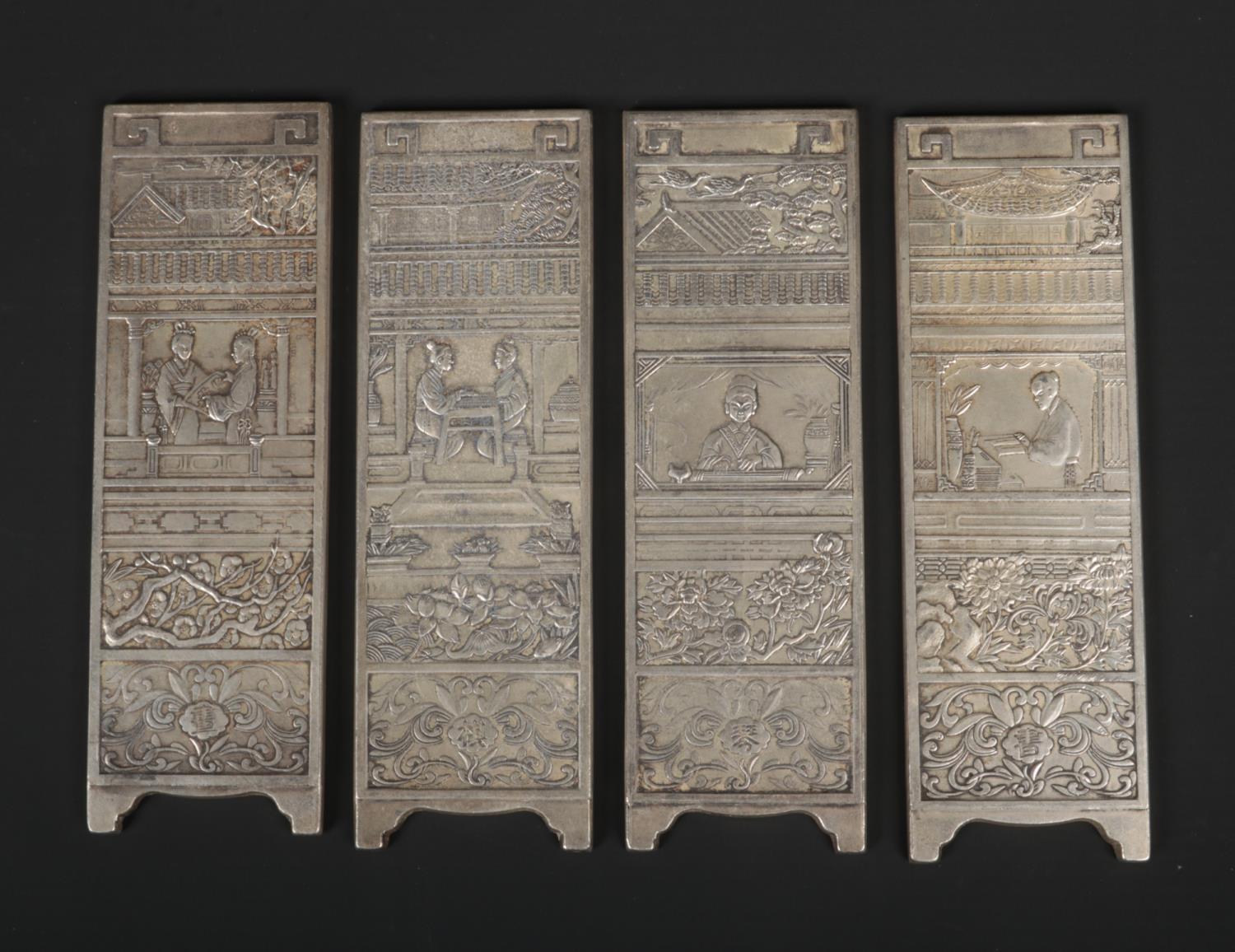 A Chinese white metal miniature four panel screen. Decorated in relief each representing a different