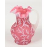 A Webb style cranberry satin glass jug decorated with flowers, 14cm. Good condition.