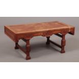 A Chinese hardwood low table raised on square supports c.1900, 47cm x 88cm, 37cm high. Heavy water