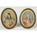 A pair of 19th century Indian Mughal oval ivory portrait miniatures of an Emperor and his companion.