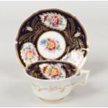 A Rockingham teacup and saucer with square handle. Ground in rich cobalt blue, with gilt foliate