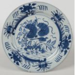 An 18th century Chinese blue and white charger. Painted in underglaze blue with a bird under a