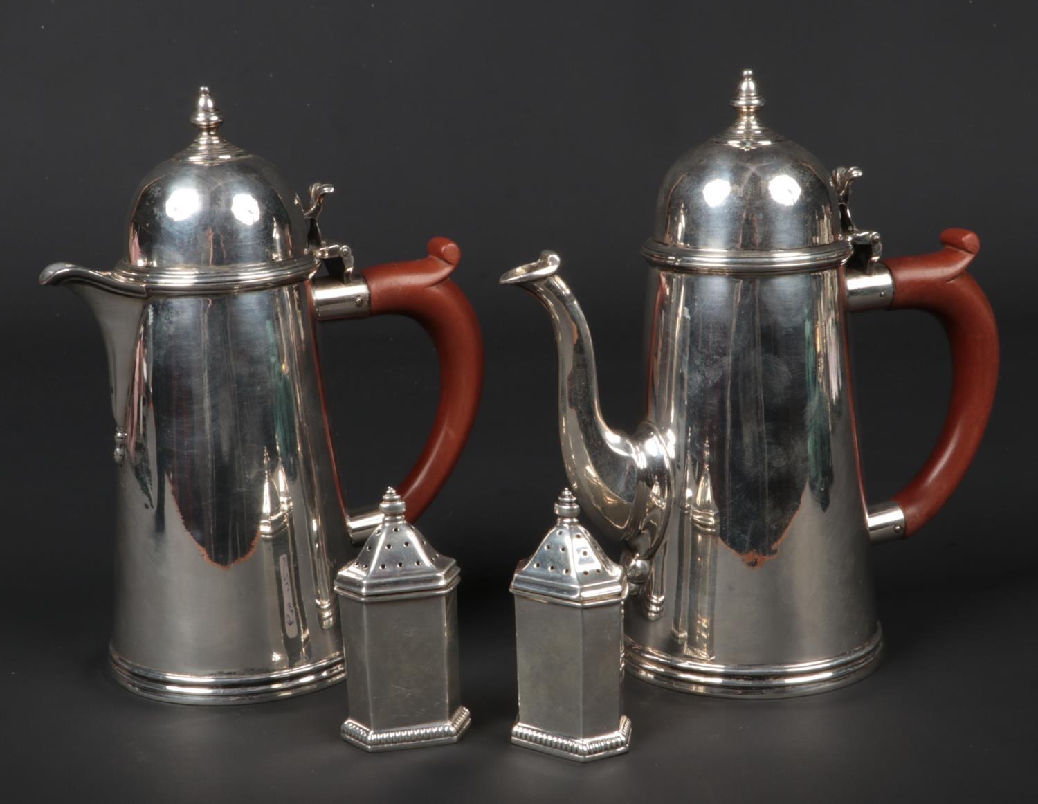 A George V silver chocolate pot and hot water jug by Goldsmiths & Silversmiths Co. Assayed London