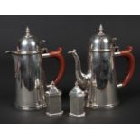 A George V silver chocolate pot and hot water jug by Goldsmiths & Silversmiths Co. Assayed London