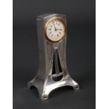 A Continental Art Nouveau silver cased desk clock. With enamel dial, pierced and stamped 935, silver
