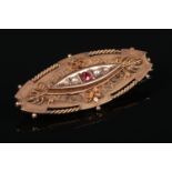 A cased 9 carat gold oval brooch. Set with a garnet and four seed pearls. Assayed Chester 1901, 5.