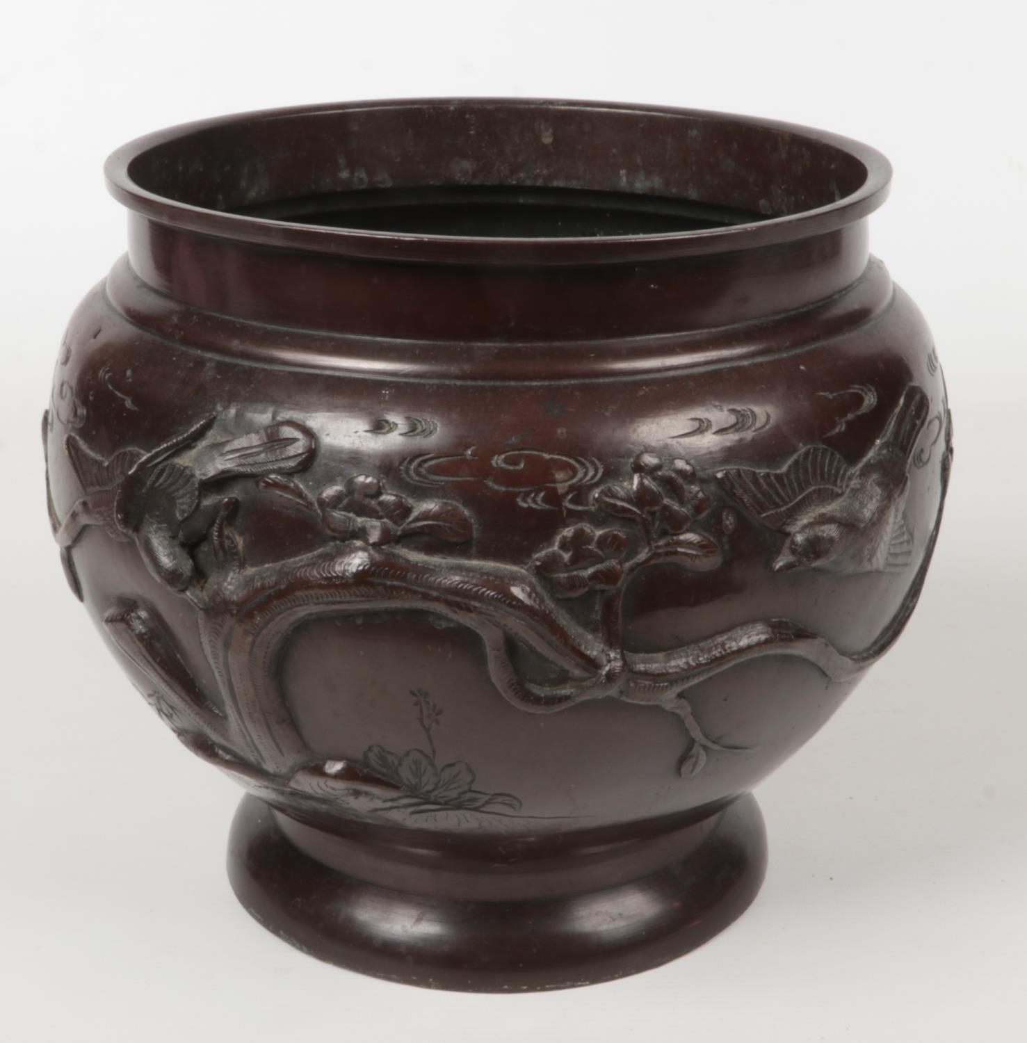 A Japanese Meiji period patinated bronze planter of plain form. Decorated in relief with birds, 25.