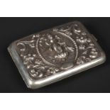 An early 20th century Indian silver cigarette case. With repousse decoration on stipple grounds