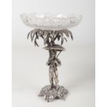 An early 20th century silver plated figural comport with cut glass dish. The base formed as a palm