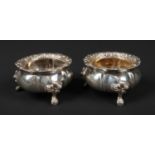 A pair of George IV silver salt sellers. With gadrooned rims and raised on cabriole feet. Assayed