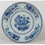 A Chinese 18th century blue and white charger. Painted in underglaze blue with fruit, flowers and
