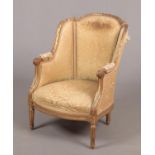 A 19th century French giltwood and gesso armchair in Louis XV style. With original silk