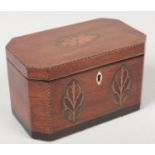 A George III mahogany tea caddy of canted rectangular form. With strung inlay, banded, having