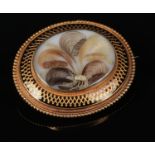 A Victorian cased yellow metal mourning brooch / pendant. With a hairwork, gold thread and seed