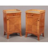 A pair of early 20th century French satinwood bedside cabinets. Quarter veneered and raised on splay
