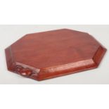 A Robert Thompson Mouseman cheeseboard of canted rectangular form. With adzed top and carved with