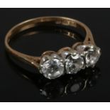 A 9ct gold and three white paste stone ring, size L.