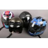 Four motorcycle helmets, to include Apex, Shox, Can and one other.