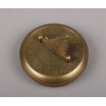 A reproduction brass sundial compass. Signed Gilbert.